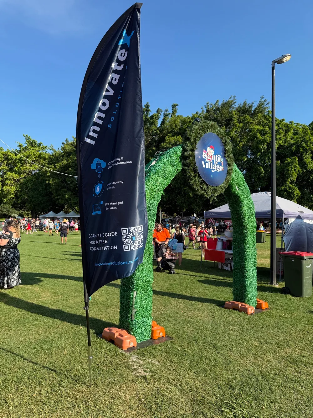 InnovateX Solutions sponsor flag at the Pine Rivers Christmas Carols