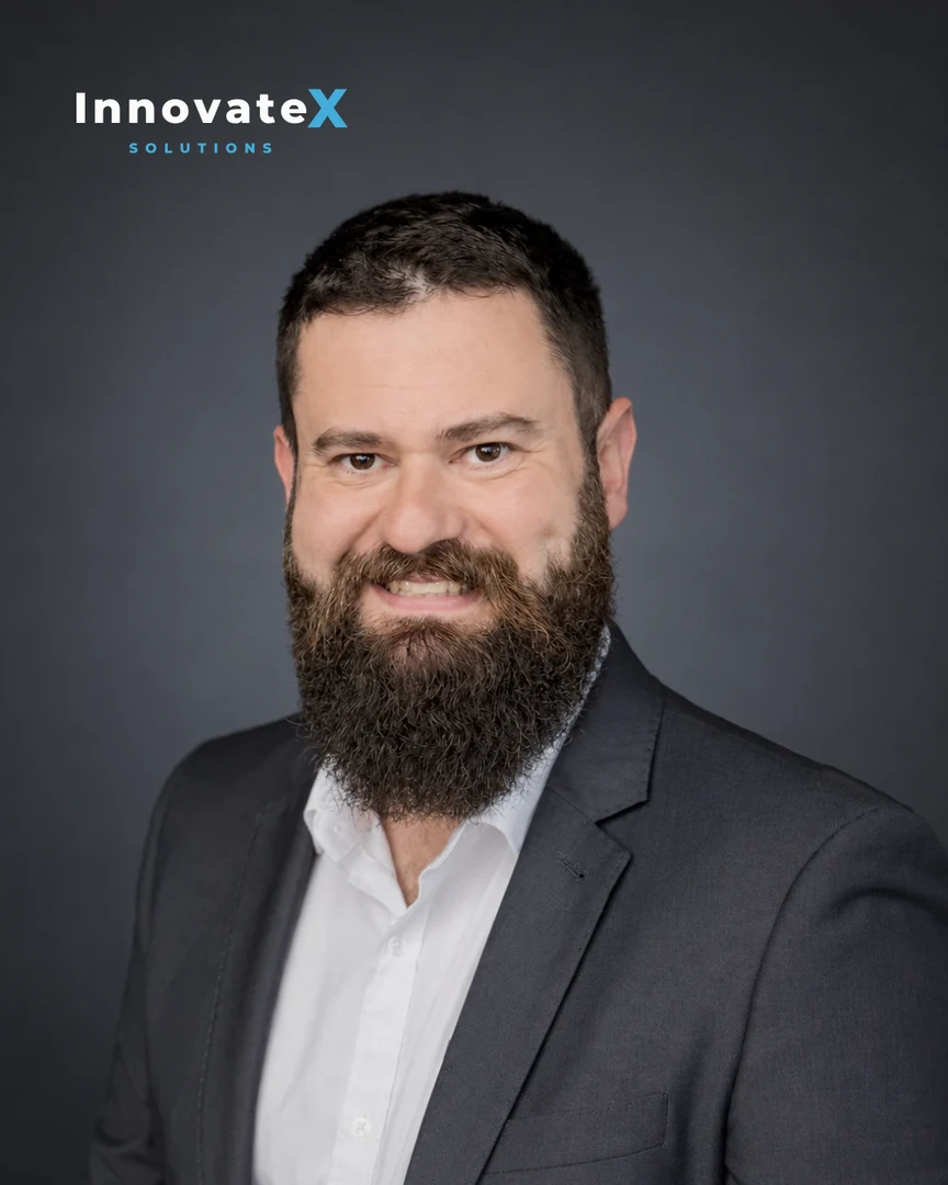 Todd Johnson in a dark suit, with InnovateX Solutions branding